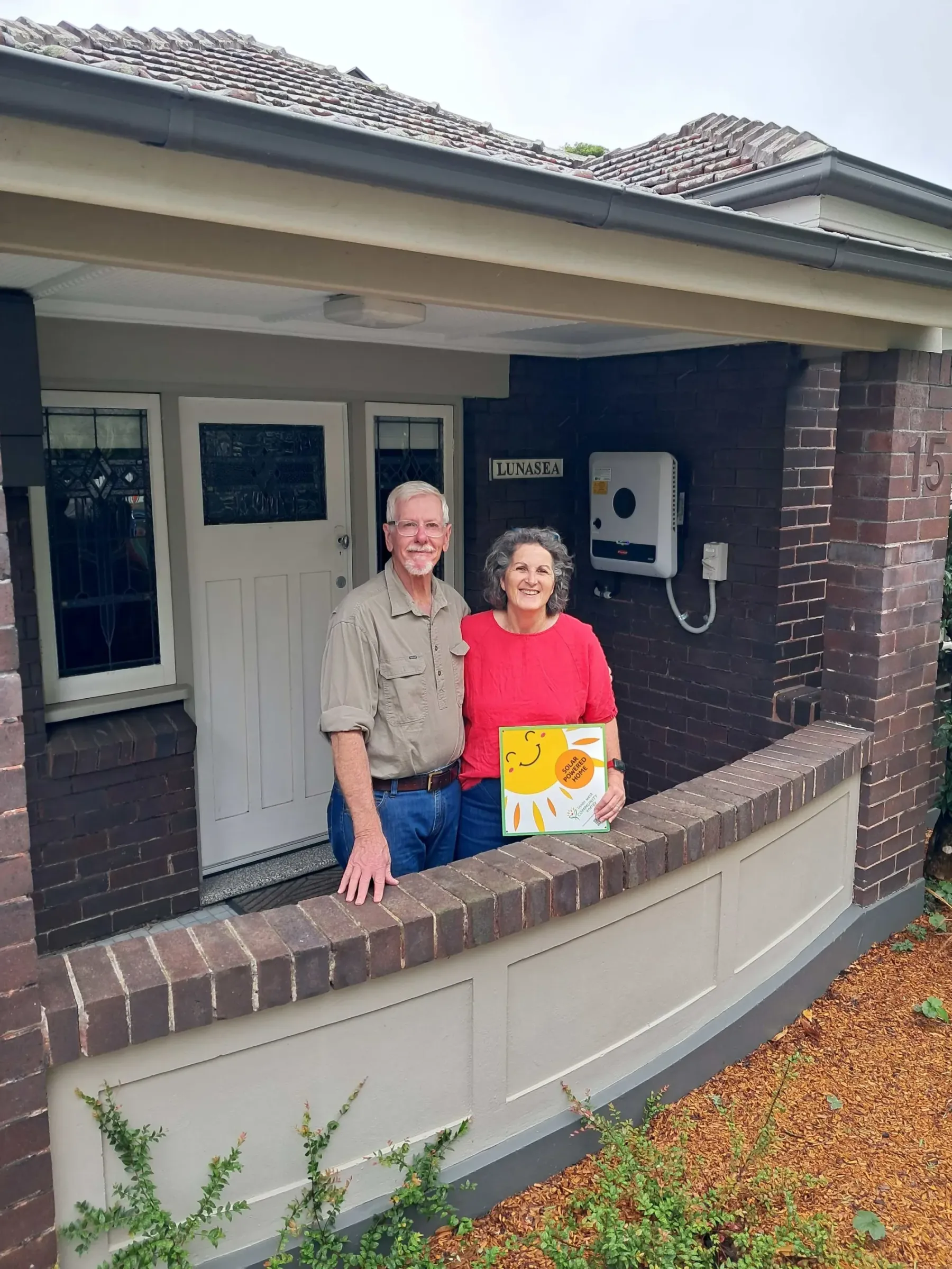 David and Clare smiling on their porch in Penshurst.