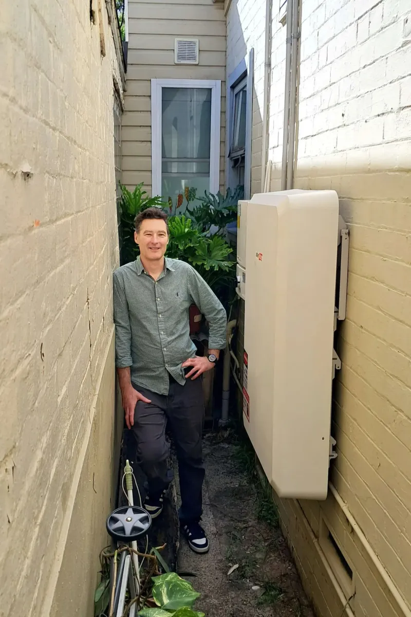 Joe standing beside his home battery in a narrow side passage