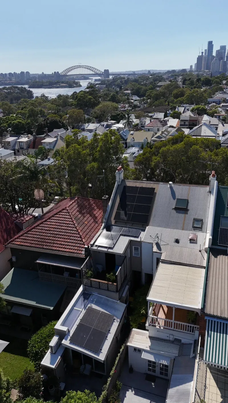 Aerial view of rooftop solar on Balmain houses with the Harbour Bridge behind